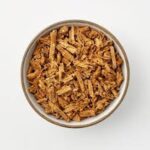 Shredded Acacia confusa root bark in a ceramic bowl — premium botanical supply from MHRBB Botanical Supply