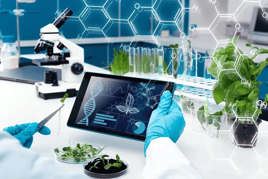 Scientist in blue gloves holding tablet with DNA and molecular data in botanical research laboratory with microscope, plant samples and test tubes